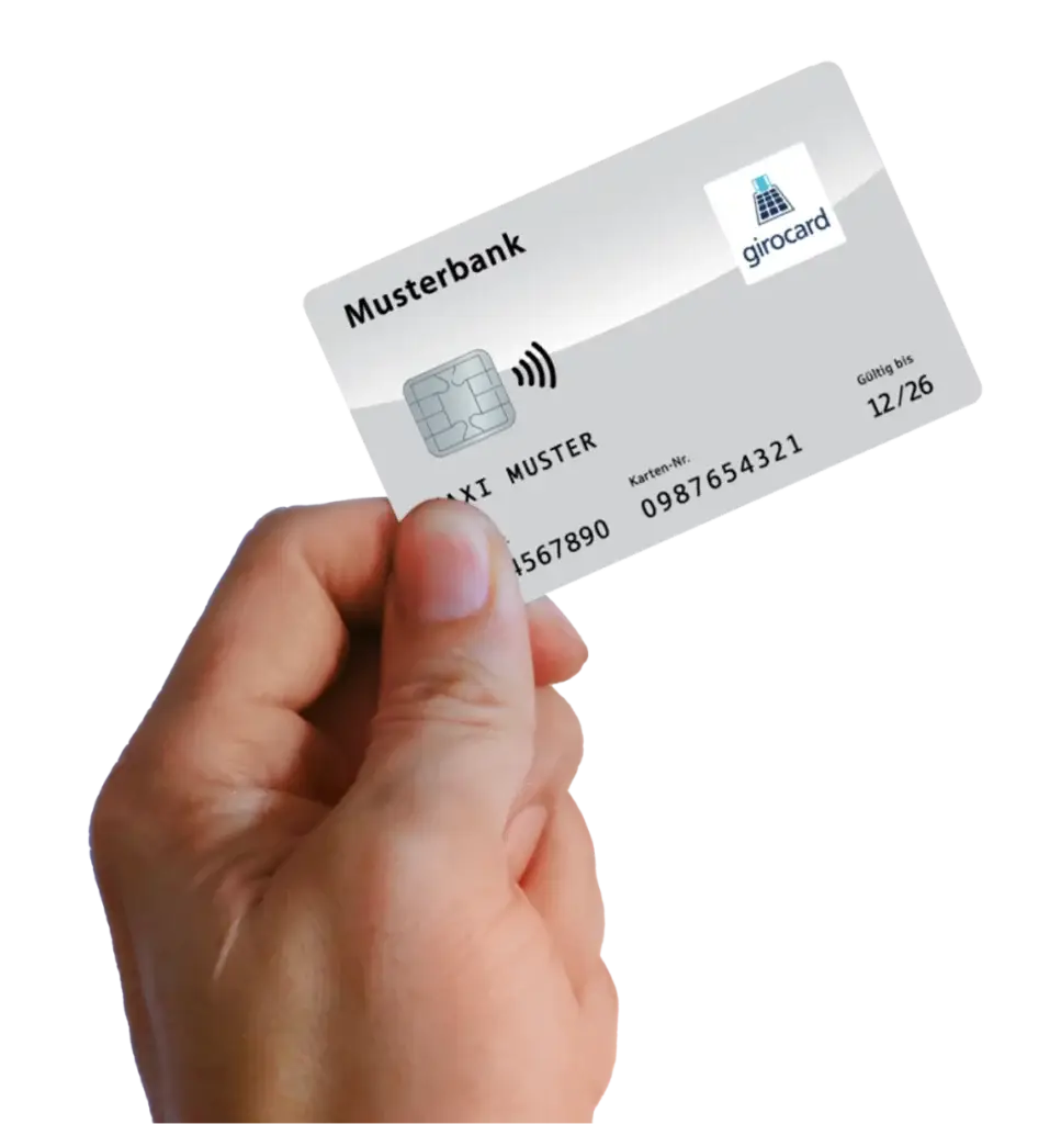Eine Hand hält eine girocard der Musterbank, die die wichtigsten Informationen wie Name, Kartennummer und Gültigkeitsdatum zeigt. Die Karte verfügt über eine kontaktlose Zahlungsfunktion.